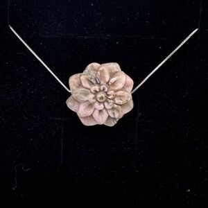 Carved rhodochrosite flower bead charm 

With 16” sterling silver needle chain.